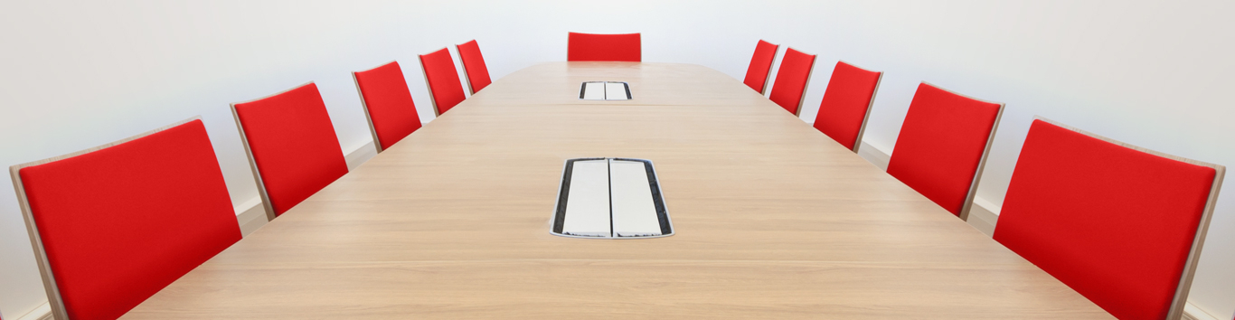 Empty board room with red chairs
